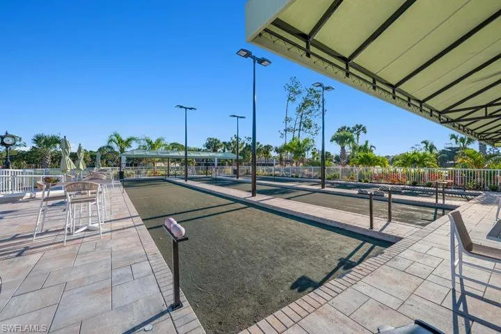 Surrounding community with a bocce ball area and a patio area