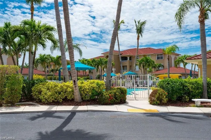 View of building exterior with a community pool