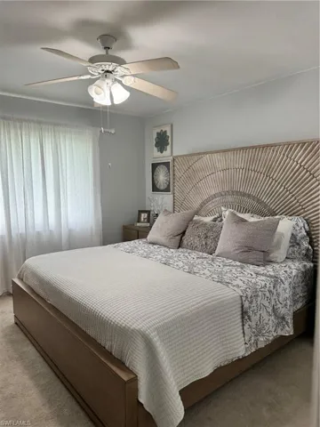 Bedroom with ceiling fan and carpet flooring