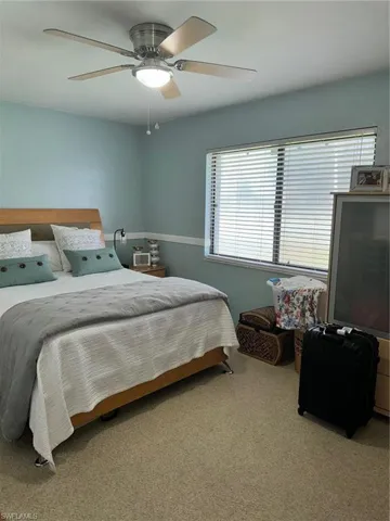 Carpeted bedroom with ceiling fan