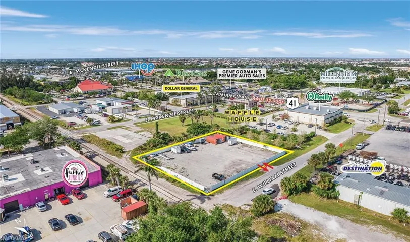 Aerial view of property's location featuring property boundaries highlighted and a commercial area