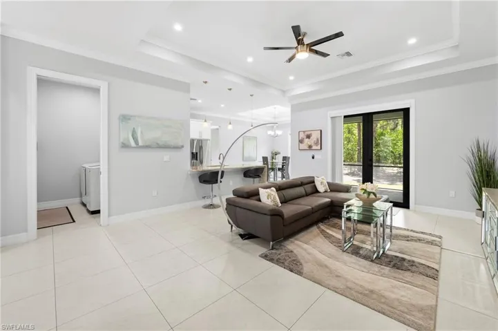 The property features light-toned tiled flooring throughout, recessed lighting, and a ceiling fan