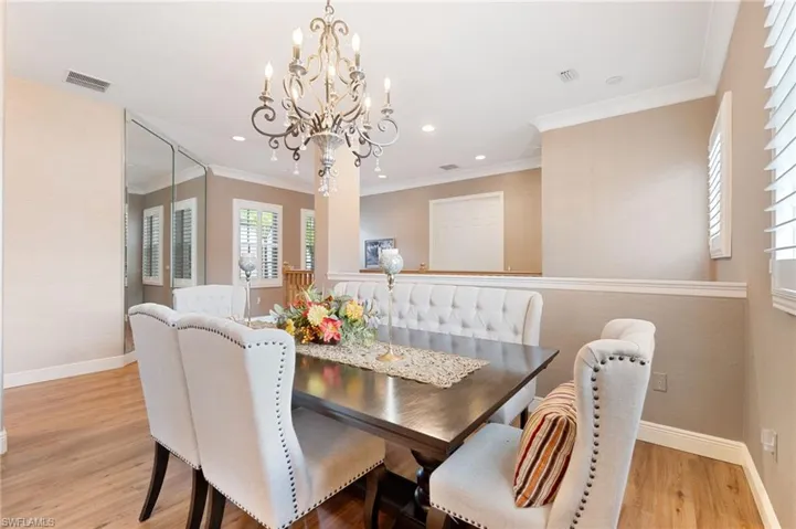 Dining area featuring wood-finish flooring, a decorative chandelier, and recessed lighting