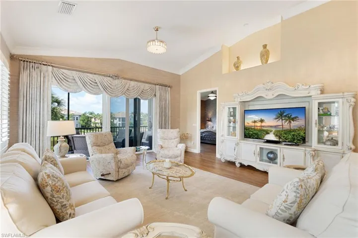 Spacious living area featuring expansive glass sliding doors opening to a screened lanai