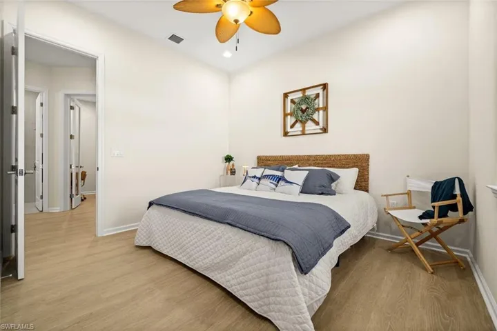 Bedroom featuring wood finished floors, ceiling fan, and recessed lighting