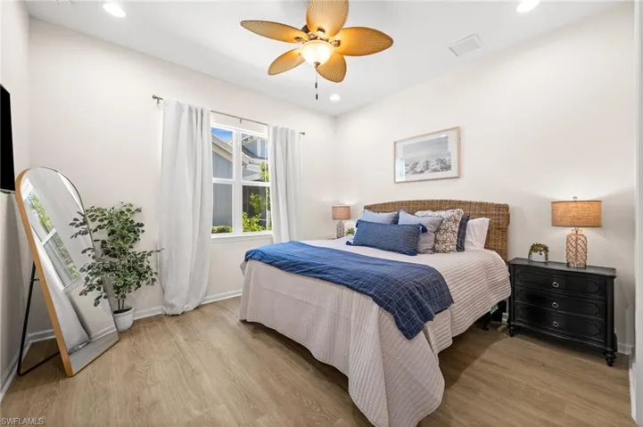 Bedroom featuring light wood-style floors, a ceiling fan, and recessed lighting