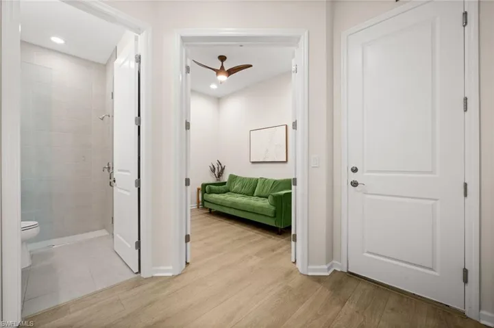 Hallway with baseboards and light wood-style flooring