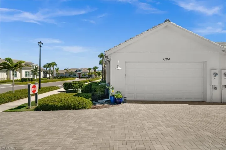 Garage with decorative driveway and a residential view
