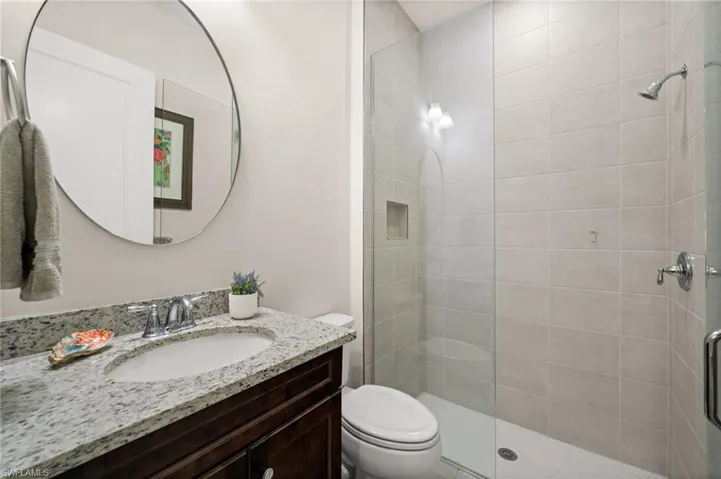 Bathroom with vanity and a shower stall