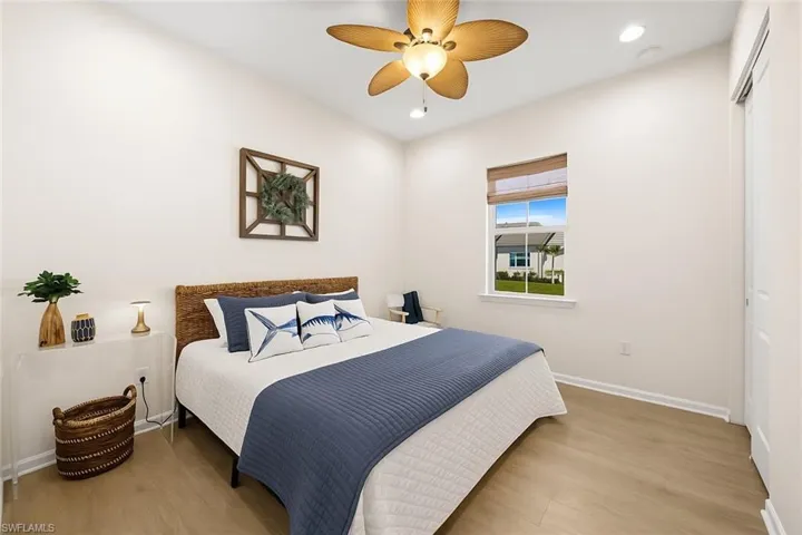 Bedroom with wood finished floors, ceiling fan, recessed lighting, and a closet