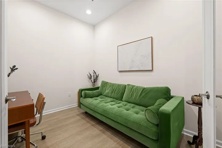 Office area with wood finished floors and recessed lighting