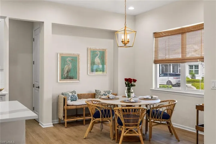 Dining area featuring light wood finished floors, recessed lighting, and a chandelier