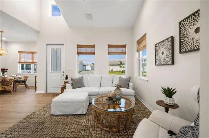 Living area with a high ceiling and light wood-style floors