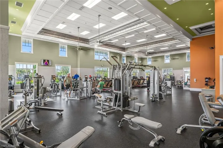 Exercise room featuring a high ceiling and ceiling fan