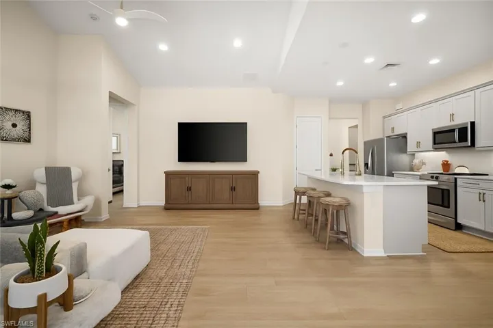 Living room featuring light wood finished floors and recessed lighting