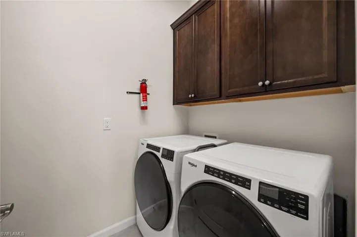 Laundry area featuring cabinet space and independent washer and dryer