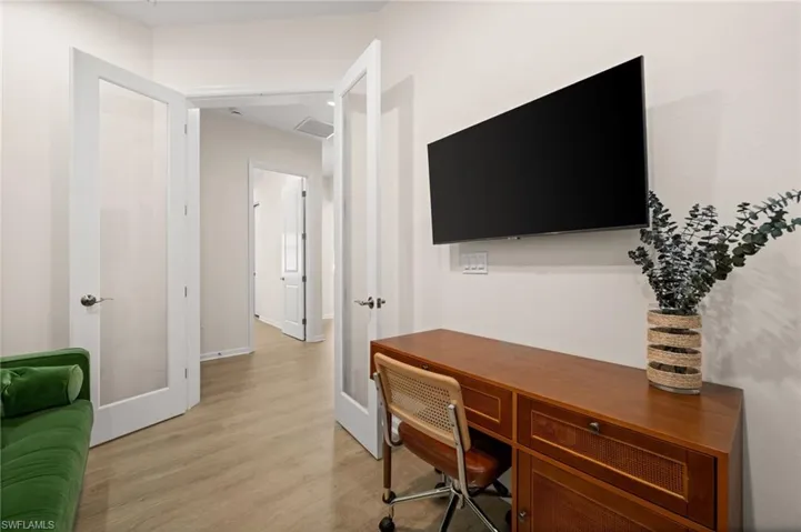 Office space with french doors and light wood finished floors