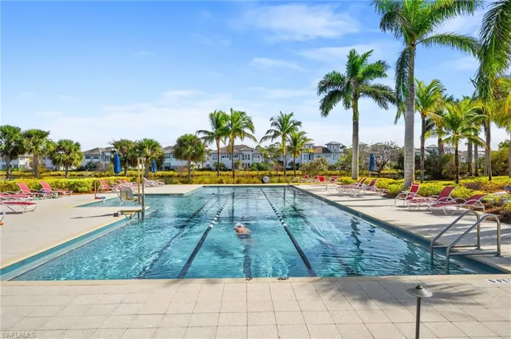 Community pool with a patio and a residential view