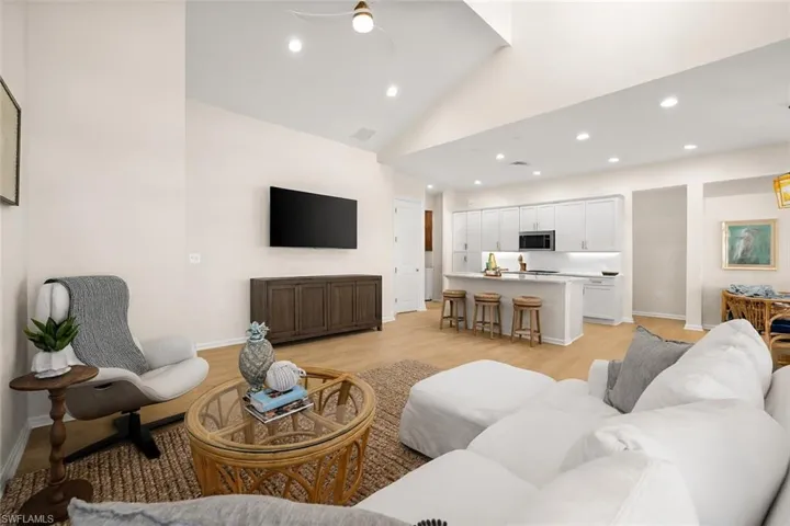 Living area featuring recessed lighting, light wood finished floors, high vaulted ceiling, and ceiling fan