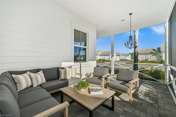 Virtually Staged Sunroom / solarium with a chandelier and a residential view