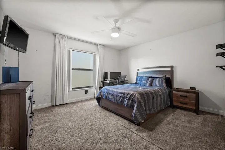 Bedroom with carpet, and ceiling fan