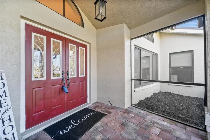 Doorway to property with stucco siding