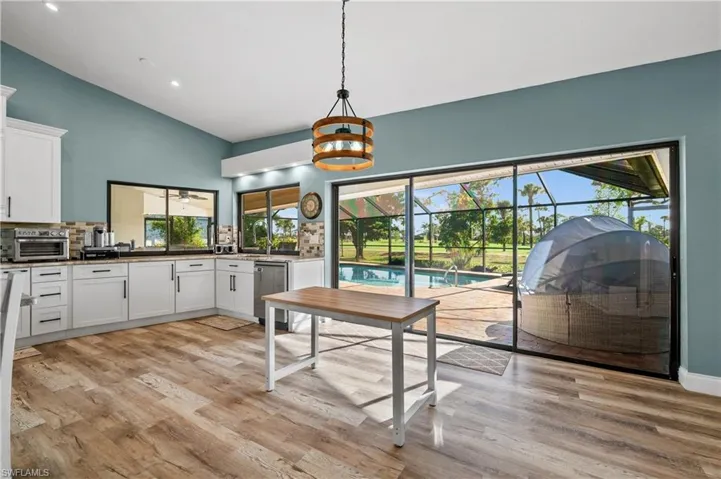 Dining area featuring  wood-style floors, plenty of natural light, high vaulted ceiling, and recessed lighting
