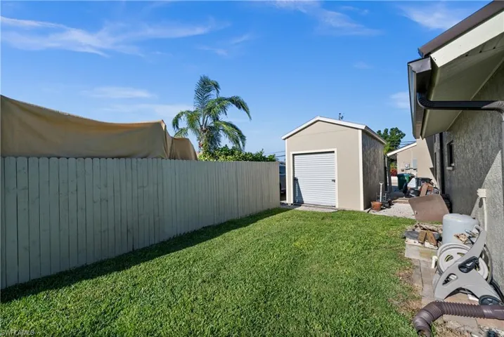 View of yard featuring a shed and an outbuilding