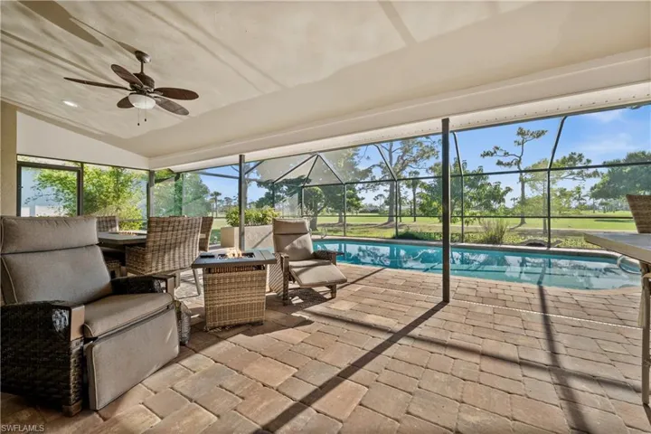 Outdoor pool featuring a patio area, ceiling fan, and an outdoor living space