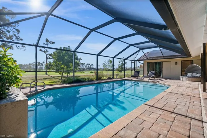 Swimming pool featuring a patio area and a lanai