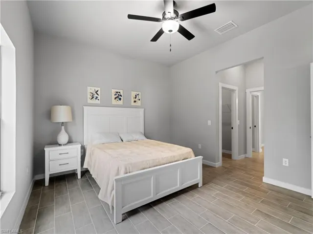 Bedroom featuring ceiling fan, a closet, and a walk in closet