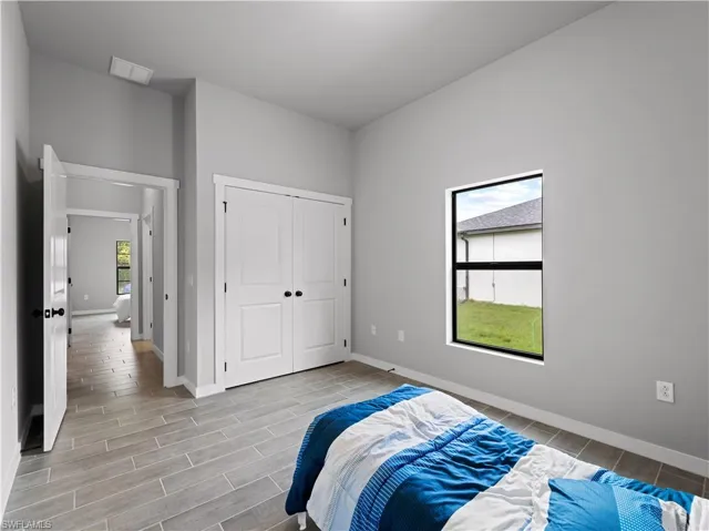 Bedroom featuring a closet and multiple windows
