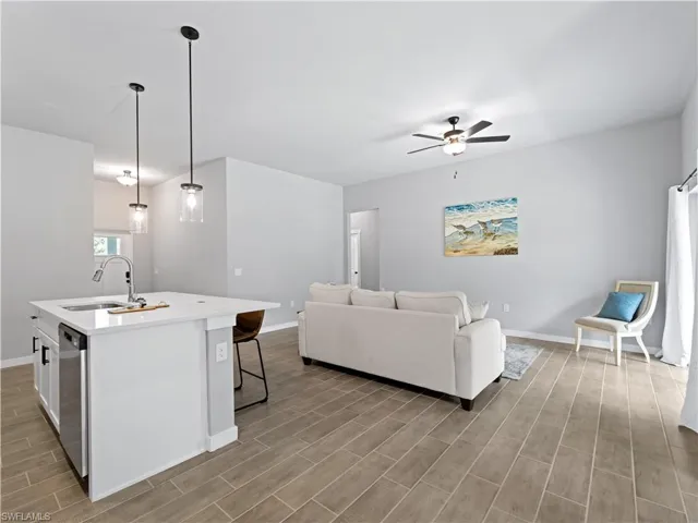 Living room featuring light hardwood / wood-style floors, sink, and ceiling fan