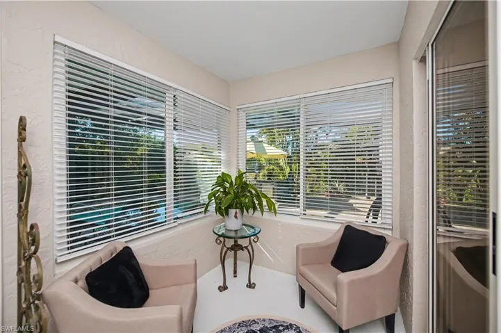 sitting area outside of office/den in the enclosed lanai area under air