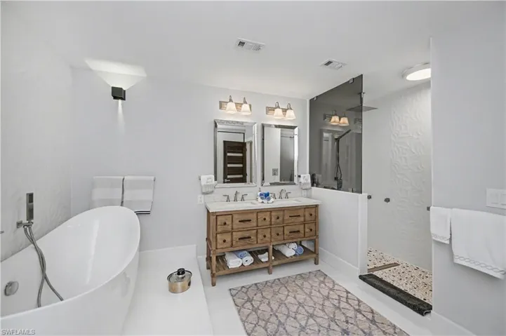 primary bathroom with separate soaking tub and shower