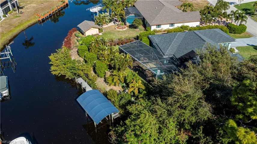 aerial of back of home boat canopy dock and canal