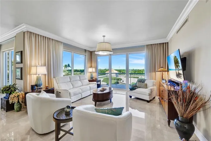 Enjoy expansive views and year-round sunsets to the west from the living and dining areas. Gorgeous marble floors and crown molding run throughout the main living areas.