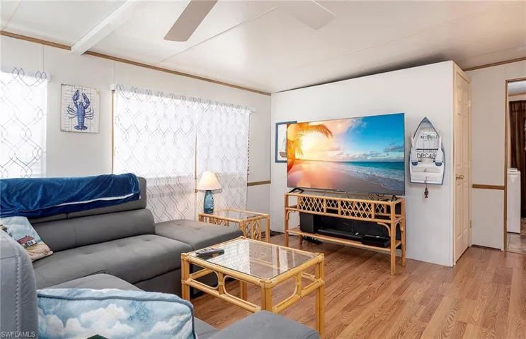 Living area with wood finished floors and a ceiling fan