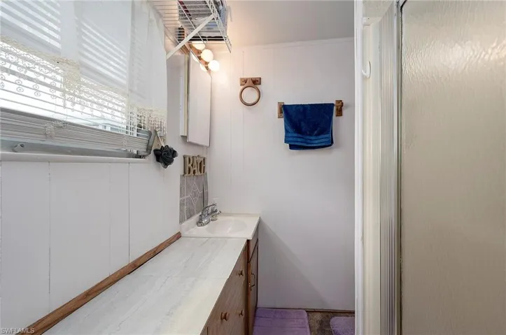 Bathroom with vanity and a shower stall