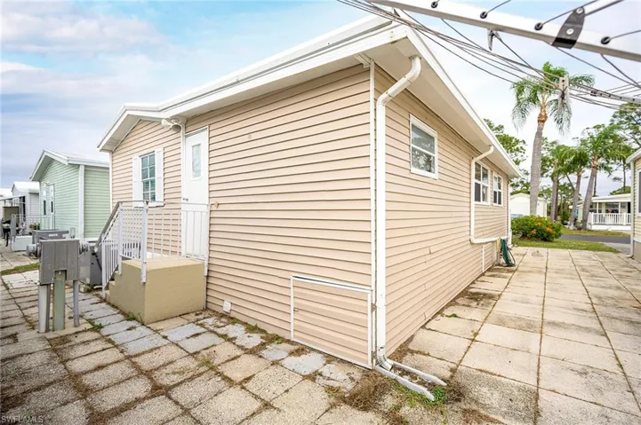 View of side of home with a patio