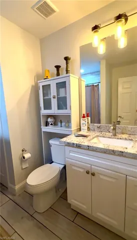 Master Bathroom with tub/shower, tile floors, custom mirrors, granite vanity top, and designer light fixtures