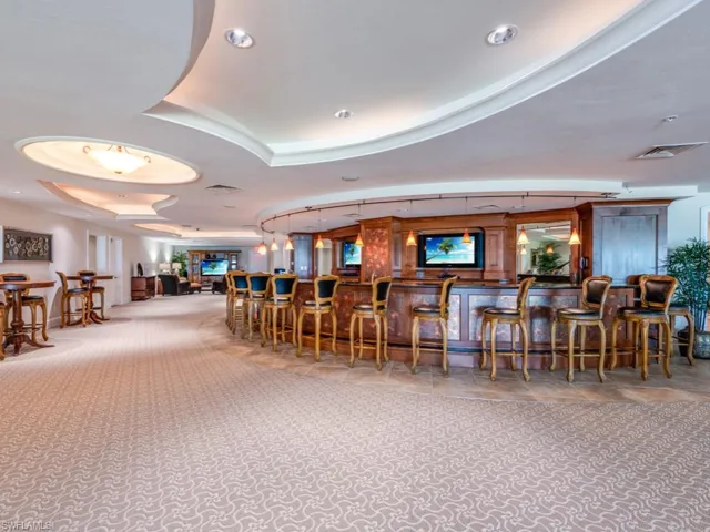 Indoor wet bar featuring carpet and recessed lighting