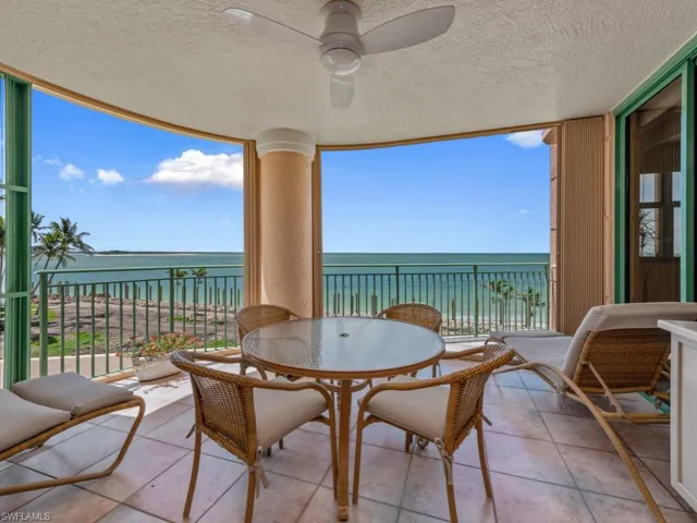 Balcony featuring a water view and outdoor dining space