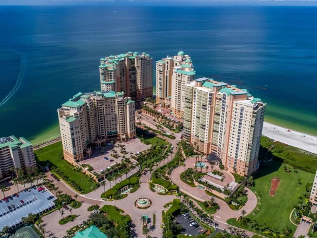 Aerial view of property and surrounding area featuring a nearby body of water