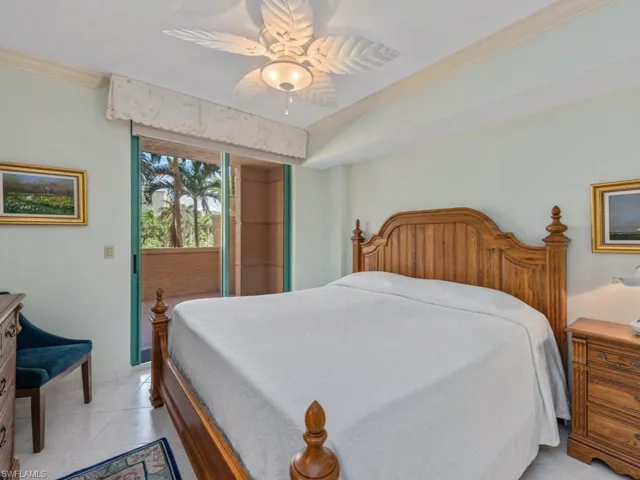 Bedroom featuring ornamental molding, ceiling fan, and access to exterior