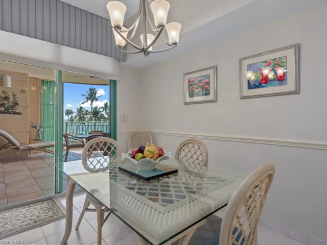 Dining area with a chandelier and light tile patterned flooring