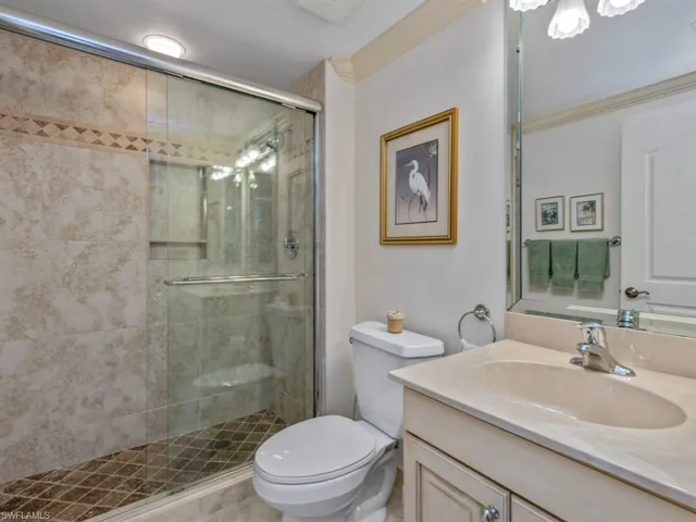 Full bathroom with vanity and a stall shower