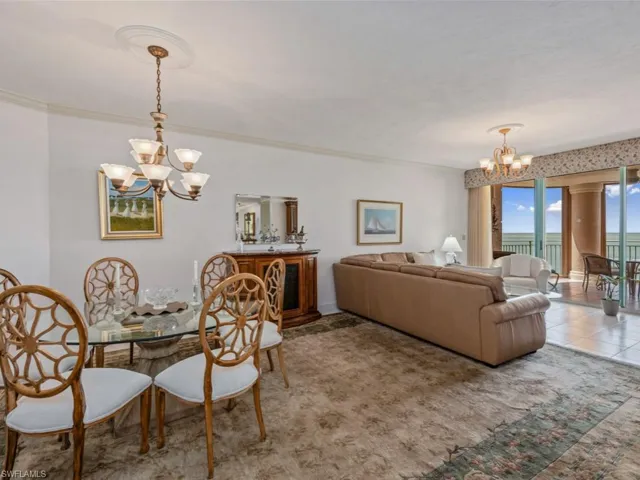Dining area featuring a chandelier and ornamental molding