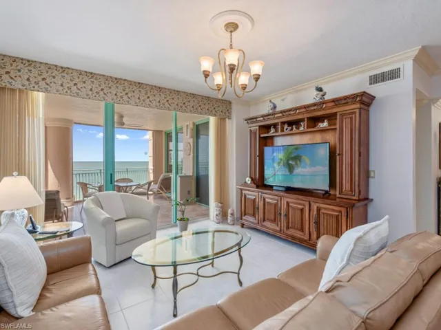 Living area with a chandelier and light tile patterned floors