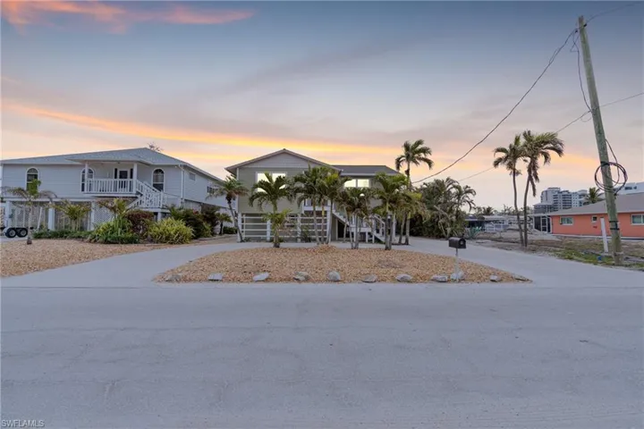 View of front of house with stairs and concrete driveway